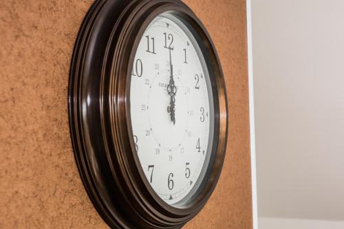 a clock hanging on a wall at Balmaha Lodges and Apartments in Balmaha