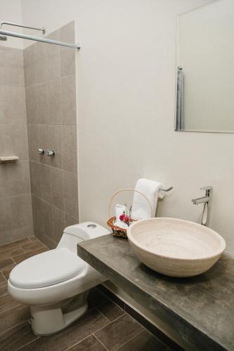 a bathroom with a toilet and a sink at casa AGAVE x Santiago de Tequila in Tequila