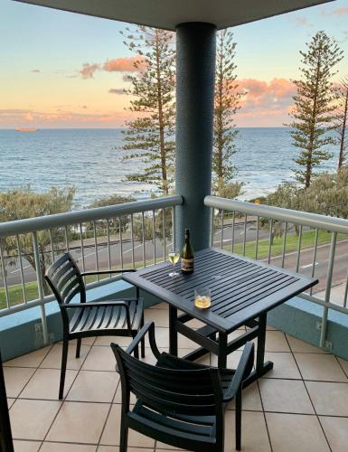 a table and chairs on a balcony overlooking the ocean at Sea Point Ocean Apartments in Caloundra