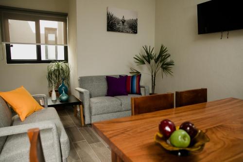 a living room with a table and a couch at Casa MAYAHUEL x Santiago de Tequila in Tequila
