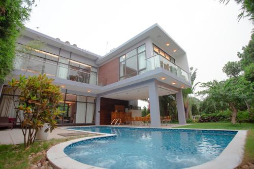 a house with a swimming pool in front of it at Bạch Yến T111-Happy Villa Đại Lải Resort in Vĩnh Phúc