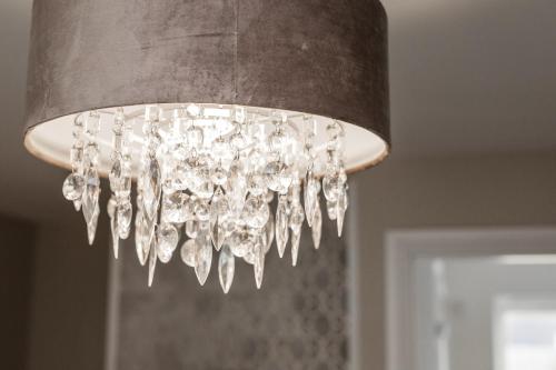 a chandelier hanging from a ceiling in a room at Balmaha Lodges and Apartments in Balmaha