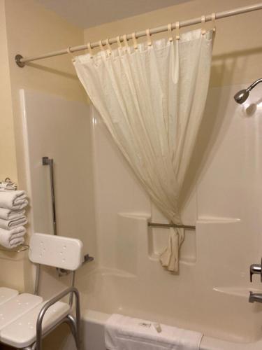 a bathroom with a shower with a shower curtain at AmeriVu Inn in Prentice