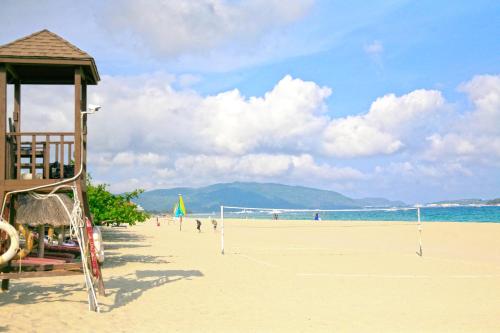 a volley ball court on a beach with people on it at Sanya Yalong Bay Villas & Spa in Sanya