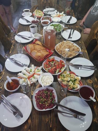 a table with plates of food on it at Family Hotel Mountain Scream in Tbilisi City