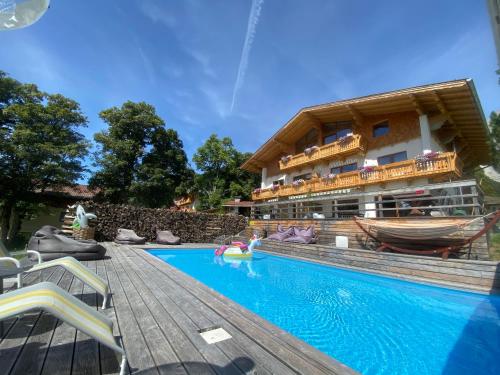 a resort with a swimming pool and a building at Haus Bernhard in Ramsau am Dachstein