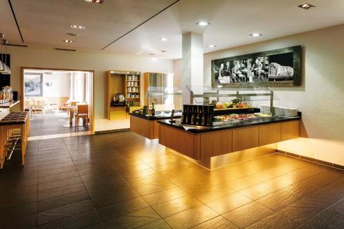 a kitchen with a counter with food on it at Hotel Alpenblick in Ohlstadt
