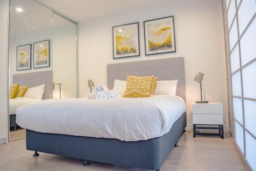 a bedroom with a large bed with yellow pillows at AirTrip Apartments on Tribune Street in Brisbane