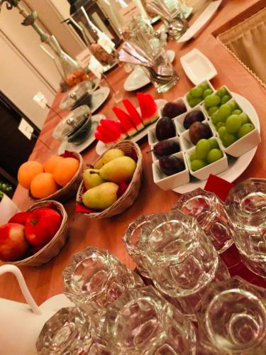 a table topped with baskets of fruit and wine glasses at Klausdorfer Hof in Schwentinental