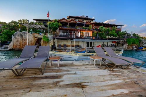 grupa krzeseł i dom na wodzie w obiekcie Ankh Pension w mieście Kaleucagız