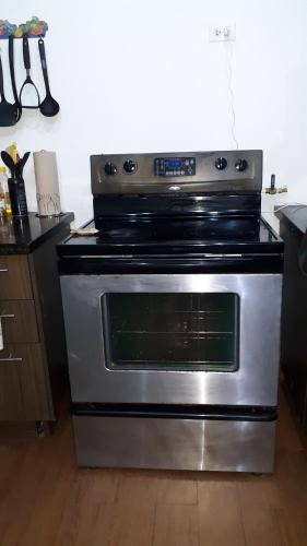 a stainless steel oven in a kitchen at Apartamento en BalaBeach María Chiquita in front of the beach 2hab in Colón