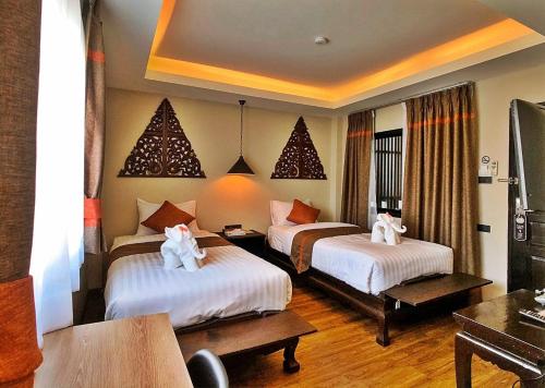 Llit o llits en una habitació de Fang Chiang Mai โรงแรมแฟงเชียงใหม่