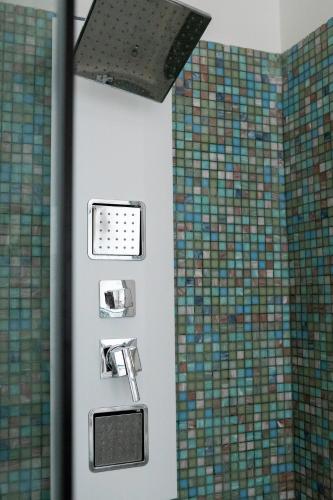 a shower in a bathroom with mosaic tiles at Spa sul tempio d'apollo in Syracuse