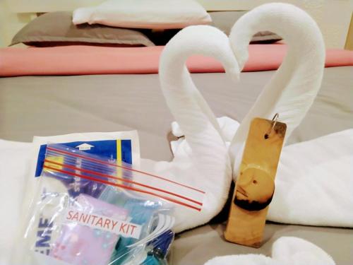 two white swans are standing next to a toothbrush at Monallan Boracay Hotel in Boracay