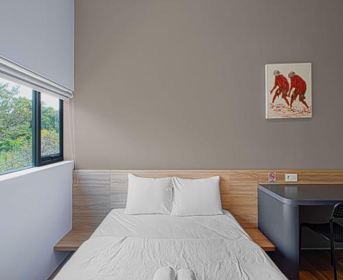 a small bedroom with a bed and a desk at M Studio Karawaci in Tangerang