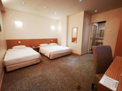 Postel nebo postele na pokoji v ubytování Prescott Hotel Bukit Bintang