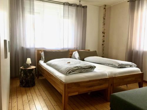 two beds in a room with a window at Ferienhaus 2 An der Rodach in Steinwiesen