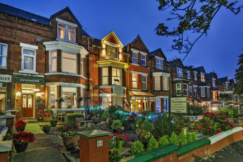 a row of houses on a street at night at The Kensington in Scarborough