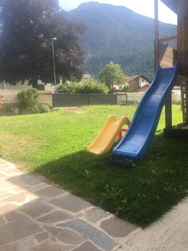 a playground with a slide in the grass at Ferienwohnung Haus File in Imst