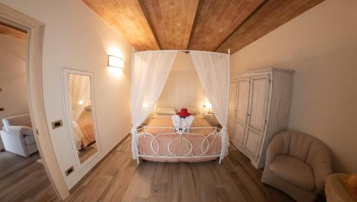 a small bedroom with a bed with a canopy at I Due Cipressi in Torrenieri