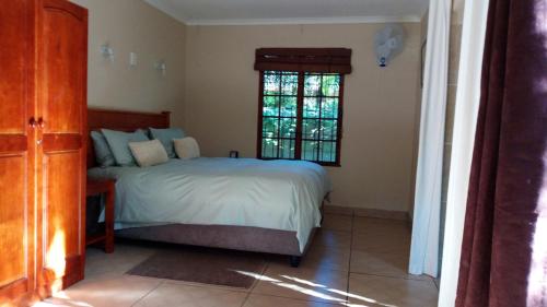 a bedroom with a bed and a window at Parkers Cottages in St Lucia