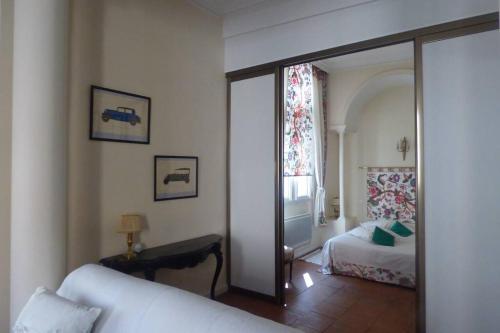 a room with a bedroom with a bed and a mirror at Logis de Sainte-Scarbes in Toulouse