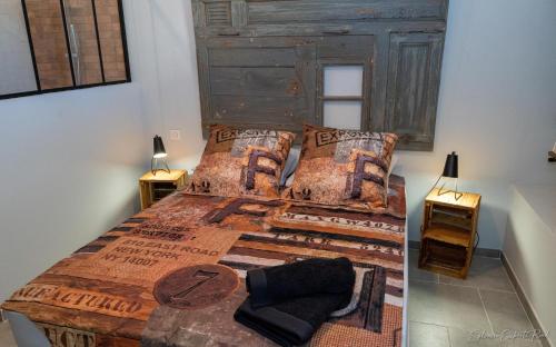 a bedroom with a large bed with a wooden headboard at I love Bergerac in Bergerac