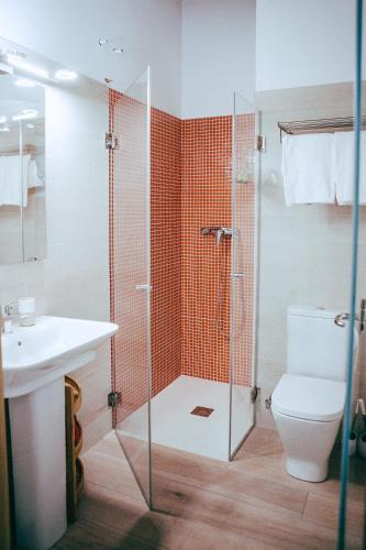 a bathroom with a shower and a toilet and a sink at hostal iratibizkar in Ochagavía