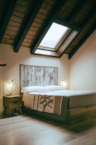 a bedroom with a large bed with a skylight at hostal iratibizkar in Ochagavía