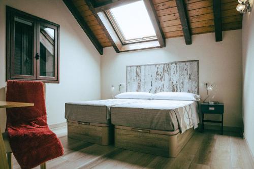 a bedroom with a large bed with a window at hostal iratibizkar in Ochagavía