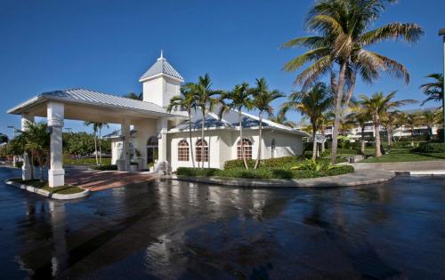 a white church with palm trees in front of it at Holiday Inn Express- North Palm Beach and IHG Hotel in Juno Beach