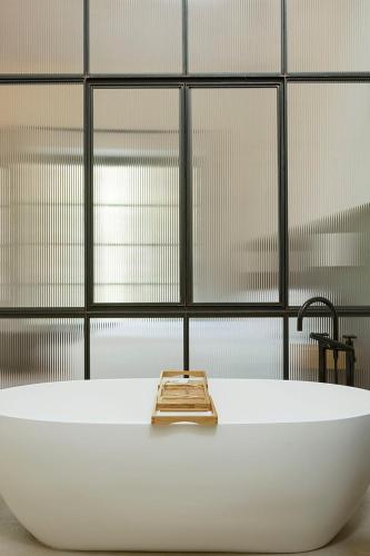 a white bath tub with a faucet in a bathroom at Dai Gresy - In Langa in Treiso