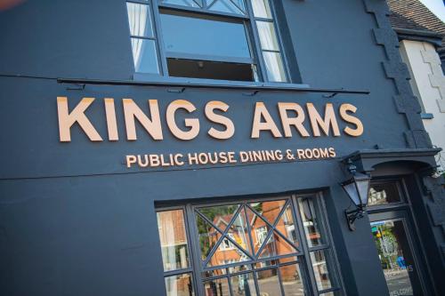 a sign for a kings arms public house dining and rooms at Kings Arms Hotel in Stansted Mountfitchet