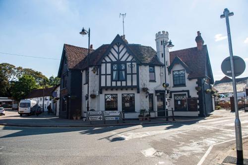 a black and white building on the corner of a street at Kings Arms Hotel in Stansted Mountfitchet