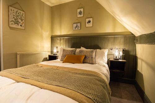 a bedroom with a large bed and two night stands at Kings Arms Hotel in Stansted Mountfitchet
