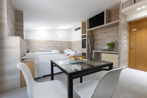 a bedroom with a bed and a table and chairs at Eurohotel in Milan