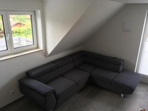 a living room with a couch and a window at Zeitfrei-Apartments in Kirchheim unter Teck
