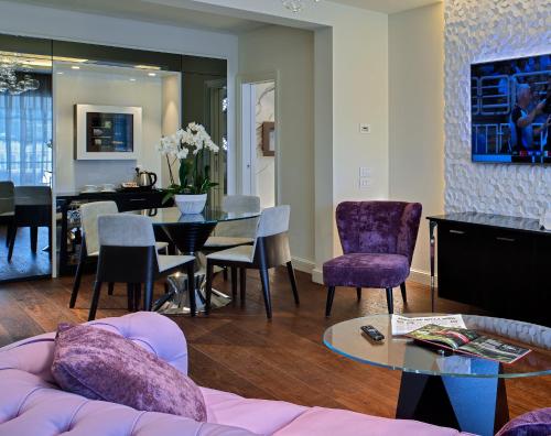 a living room with a couch and a table and chairs at Tritone LUXURY HOTEL THERMAE & SPA in Abano Terme