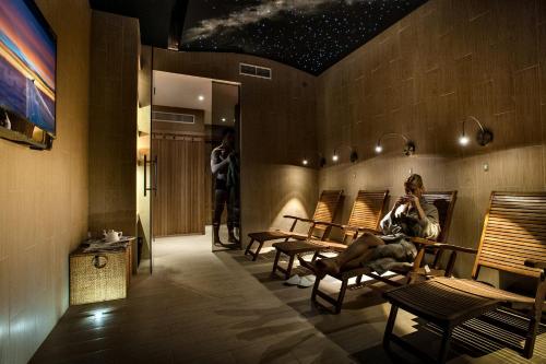a woman sitting on a chair in a waiting room at Eurohotel in Milan