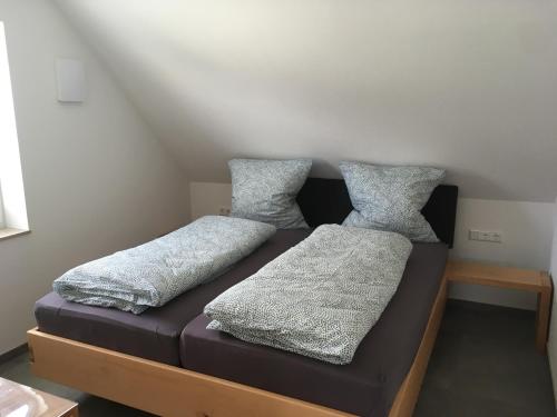 two pillows on a bed in a room at Zeitfrei-Apartments in Kirchheim unter Teck