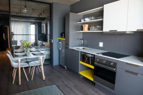 a kitchen with a table and a dining room at Wex 1 Apartments in Cape Town
