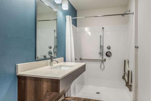 a bathroom with a sink and a shower at WoodSpring Suites Greenville Haywood Mall in Greenville