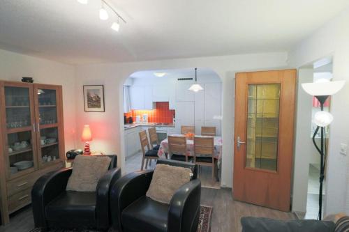 a living room with chairs and a dining room at Casa Berger in Bolgen