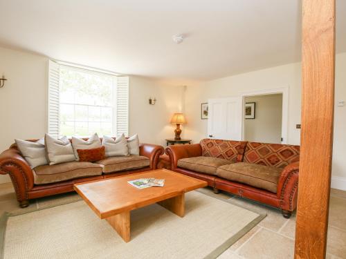 a living room with two couches and a coffee table at Shifford Manor Farm in Witney