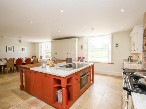 a kitchen with an island in the middle of it at Shifford Manor Farm in Witney