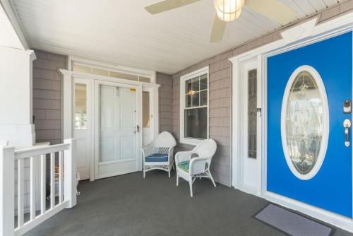 a porch with two chairs and a blue wall at Beach Block 7 bdrms Parking Patio and Sunroom in Atlantic City
