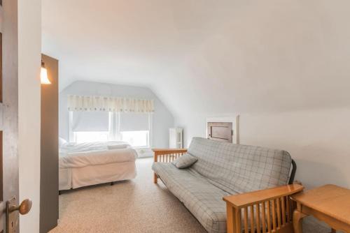 a living room with a couch and a bed at Beach Block 7 bdrms Parking Patio and Sunroom in Atlantic City