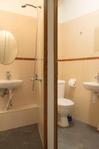 a bathroom with a toilet and a sink at The Sunny Guest House of Veliko Tarnovo-Amazing View, Top Location in Veliko Tŭrnovo