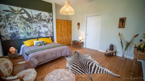 a bedroom with a bed and a zebra rug at I love Bergerac in Bergerac