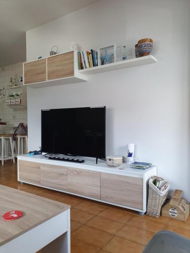 a living room with a large flat screen tv at Muxía Apartamento Malecón enfrente al puerto 4 personas in Muxia